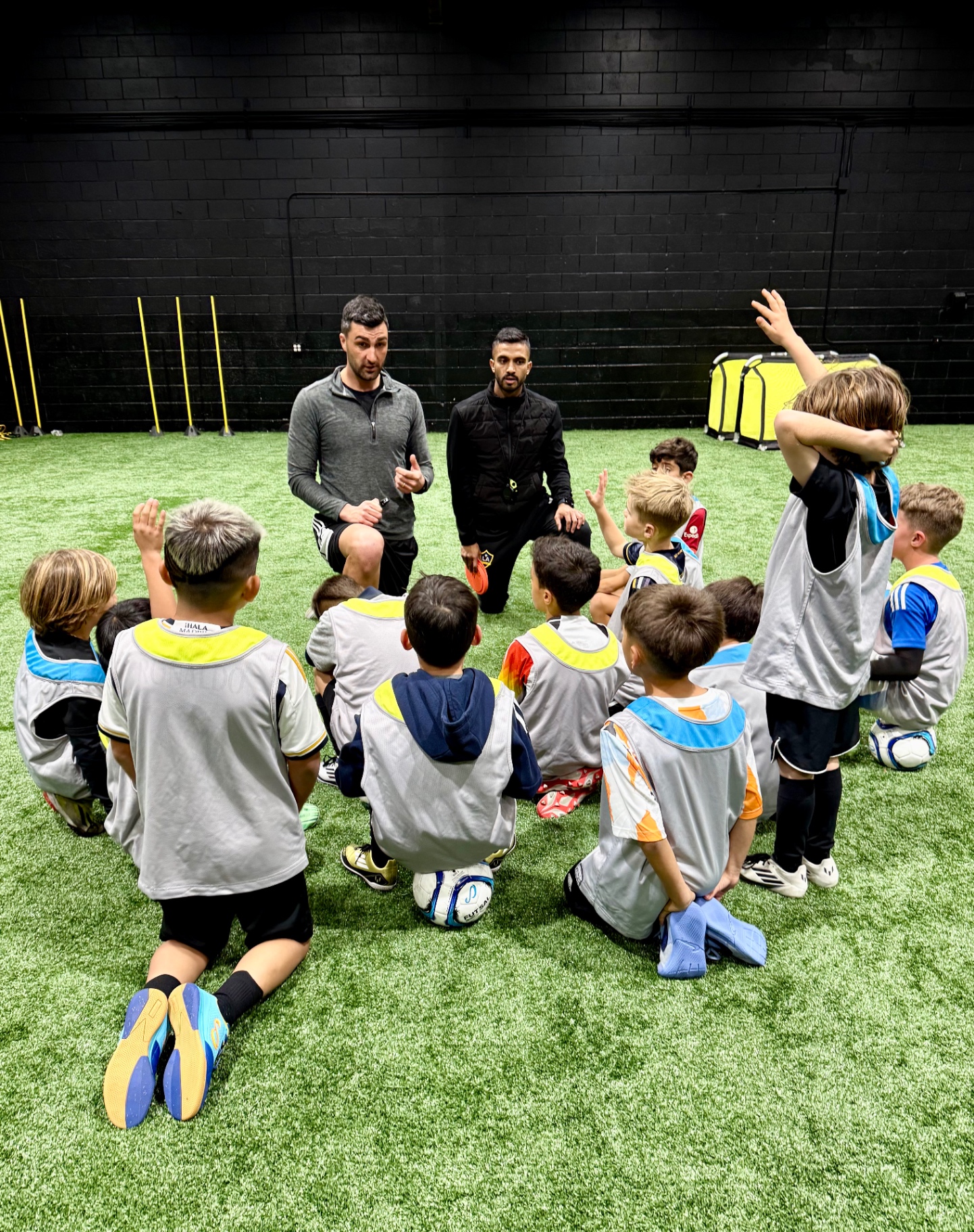 Coaches leading a tactical huddle with young players at Stadium Southbay